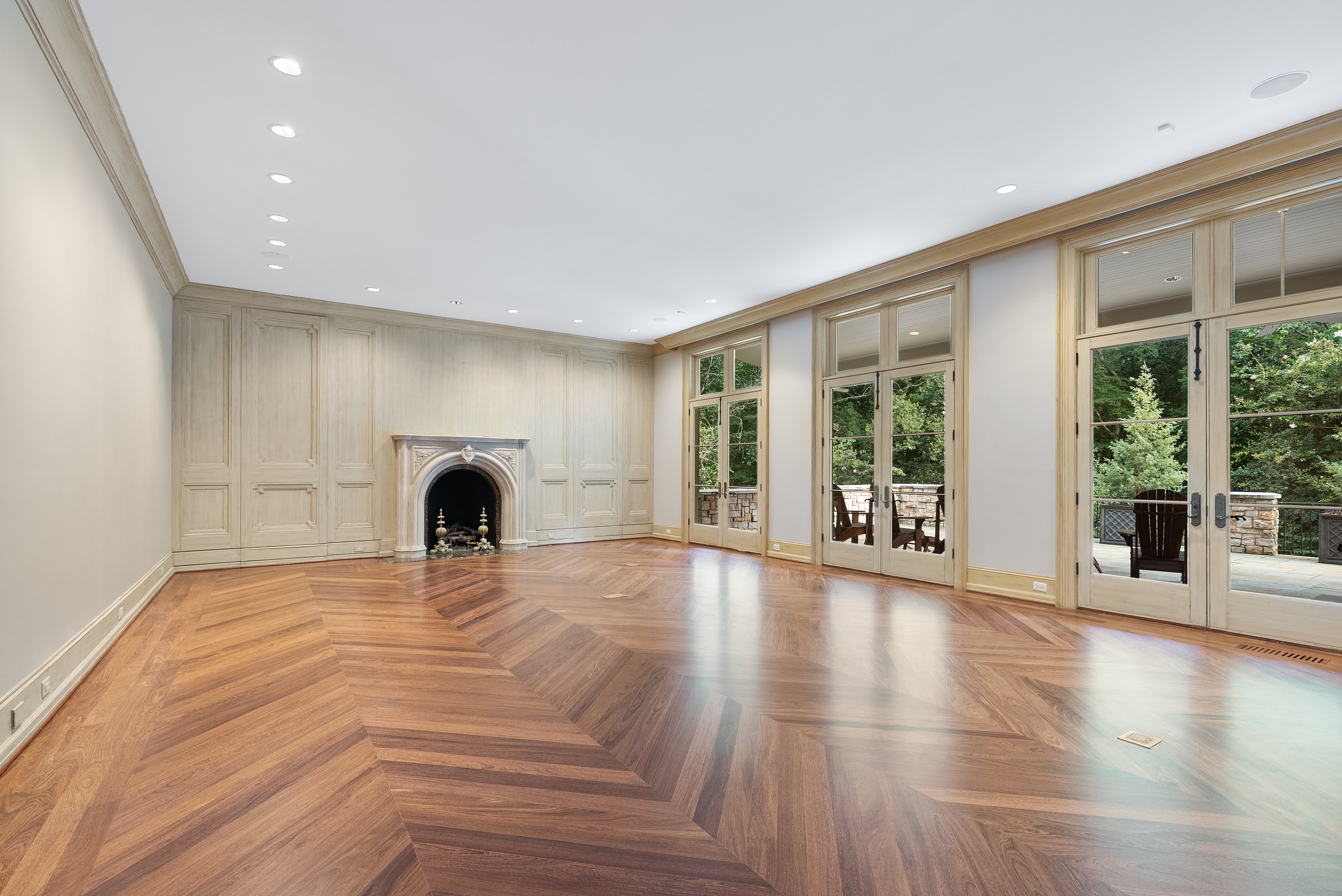 Grand room with doors to backyard and a fireplace