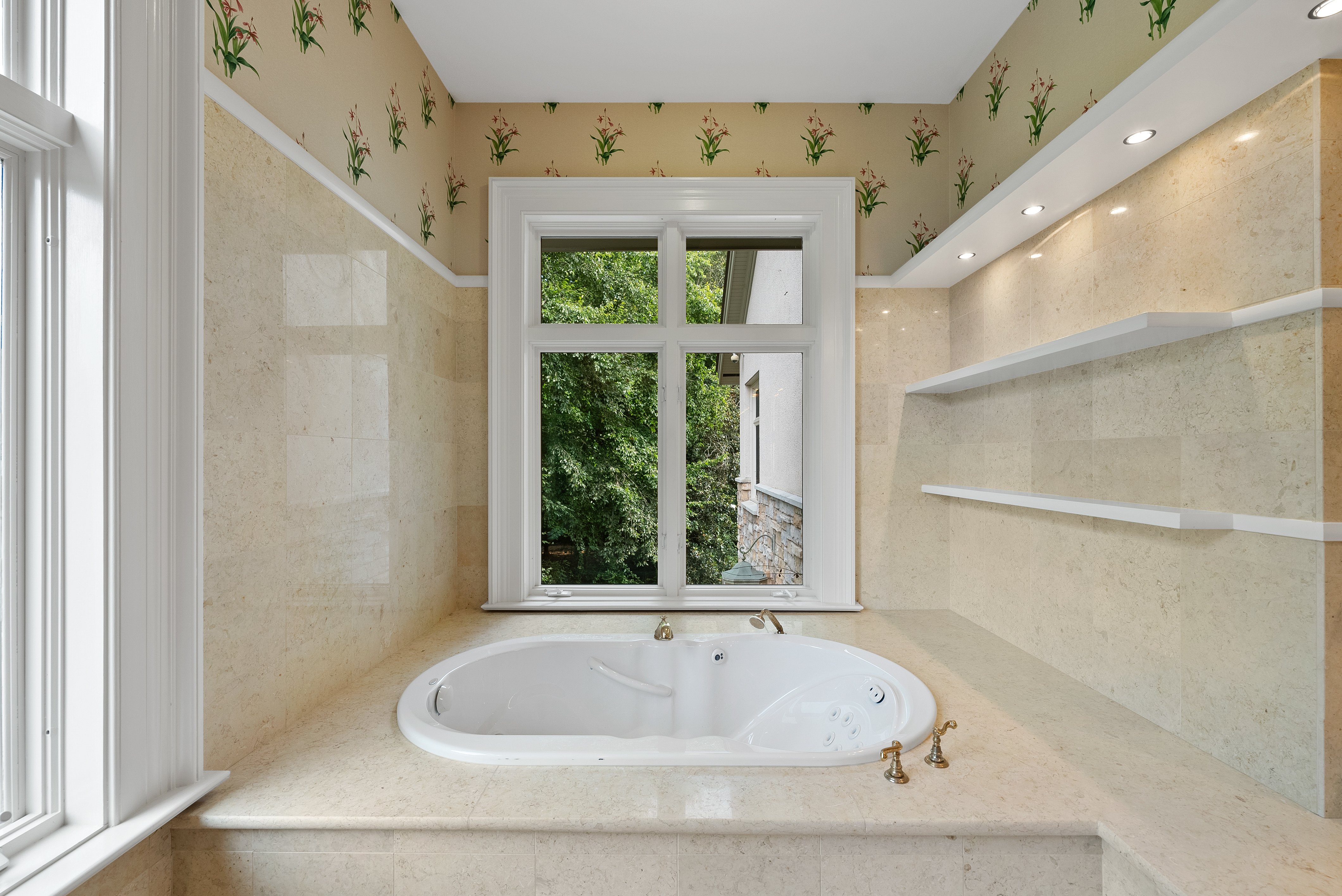 A large tub in an alcove by a window