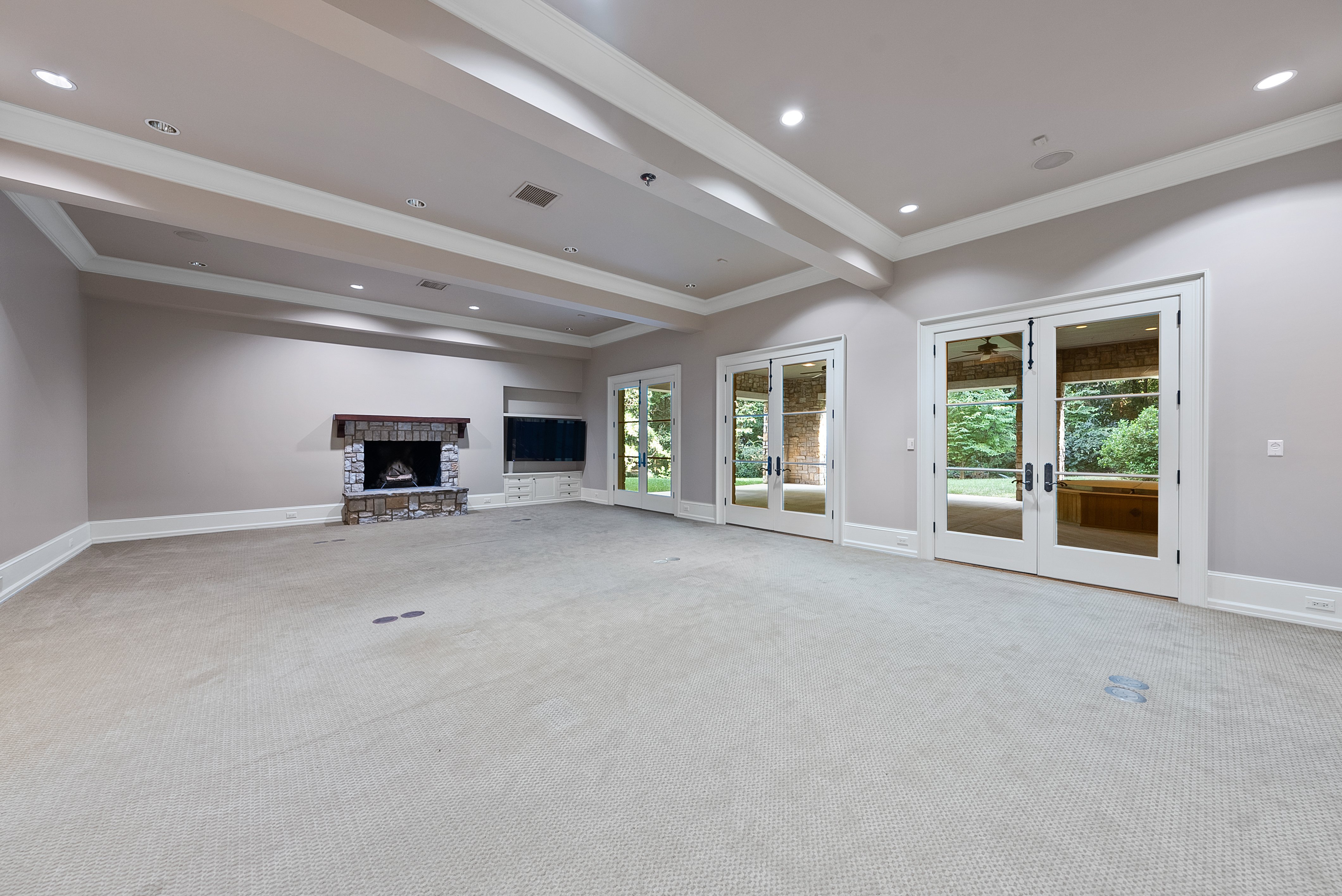 Interior of a bonus room, with the patio and jacuzzi just outside the French doors