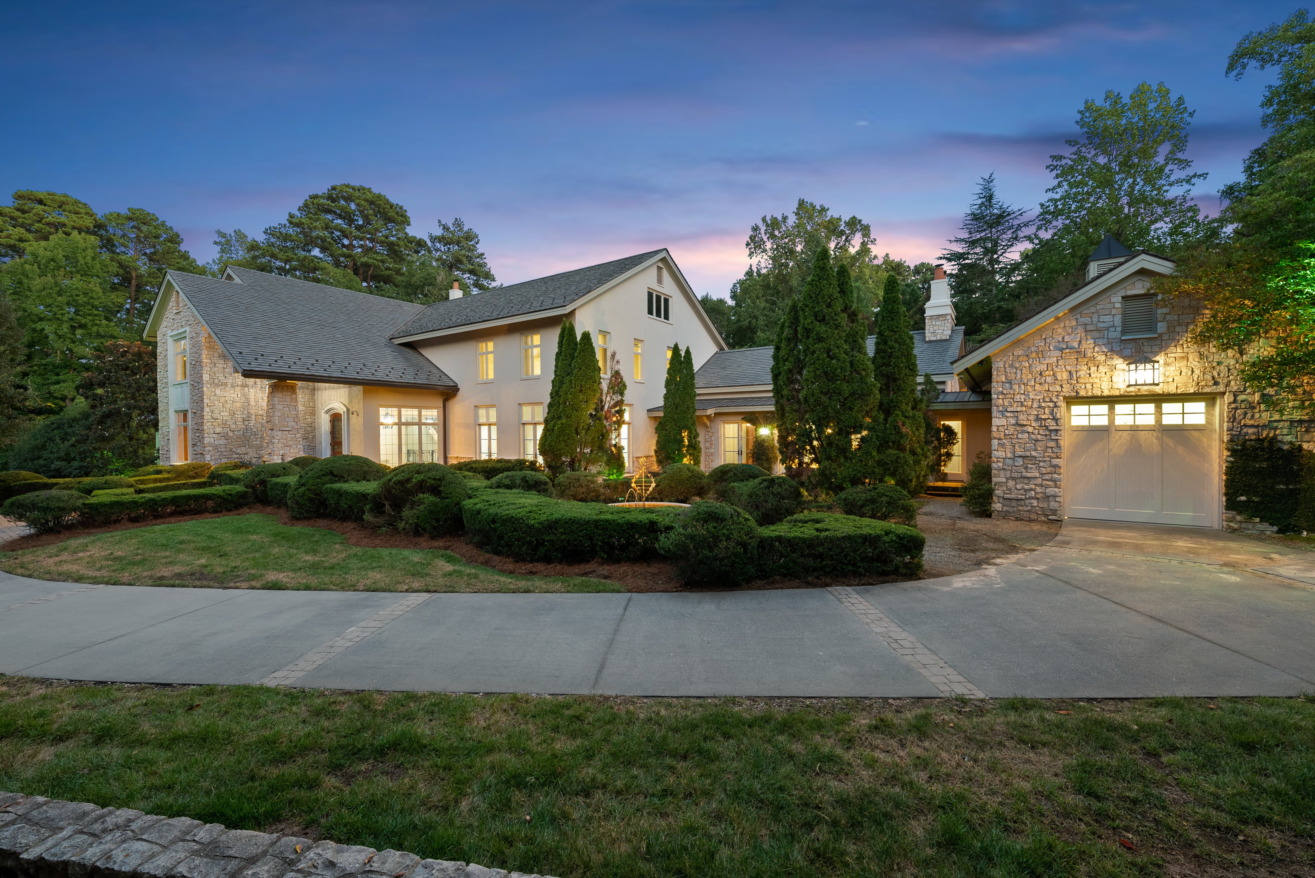 A dusk, or twilight view of the home exterior.